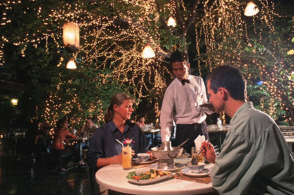 A couple of tourists enjoy dinner
