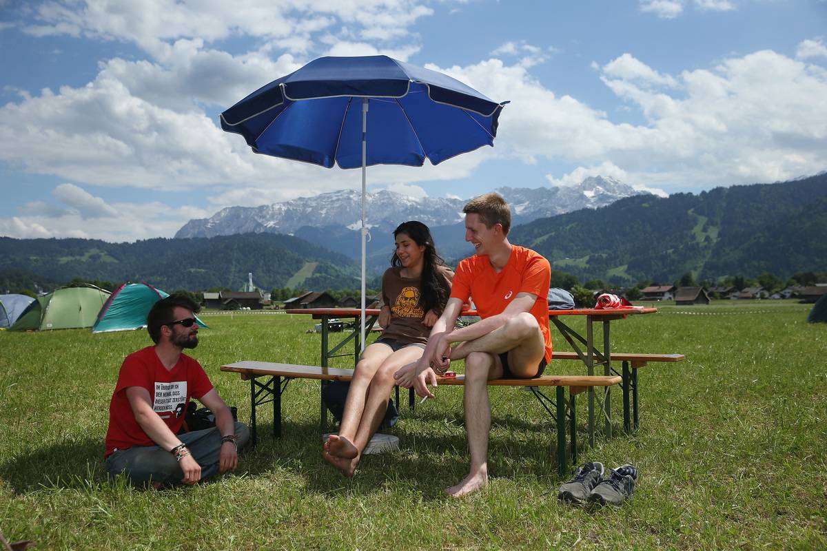 young people sitting together at campsite