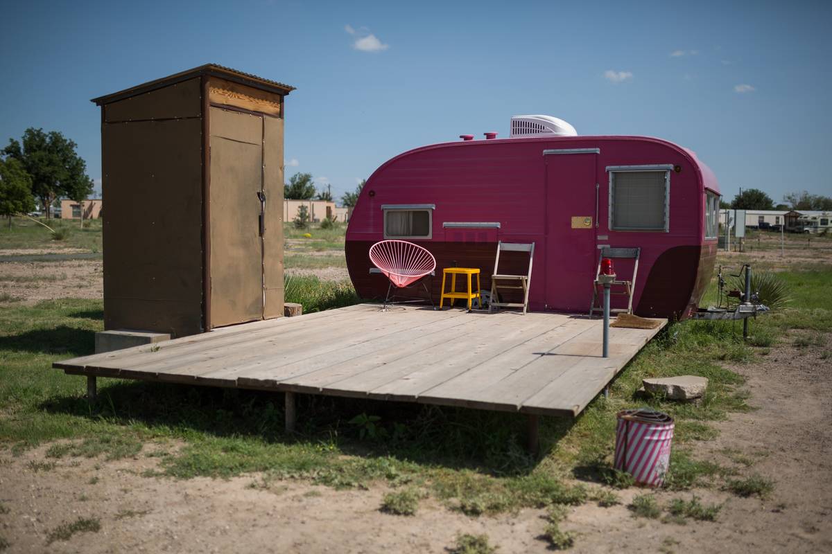 Cute pink camping trailer with an outdoor bathroom