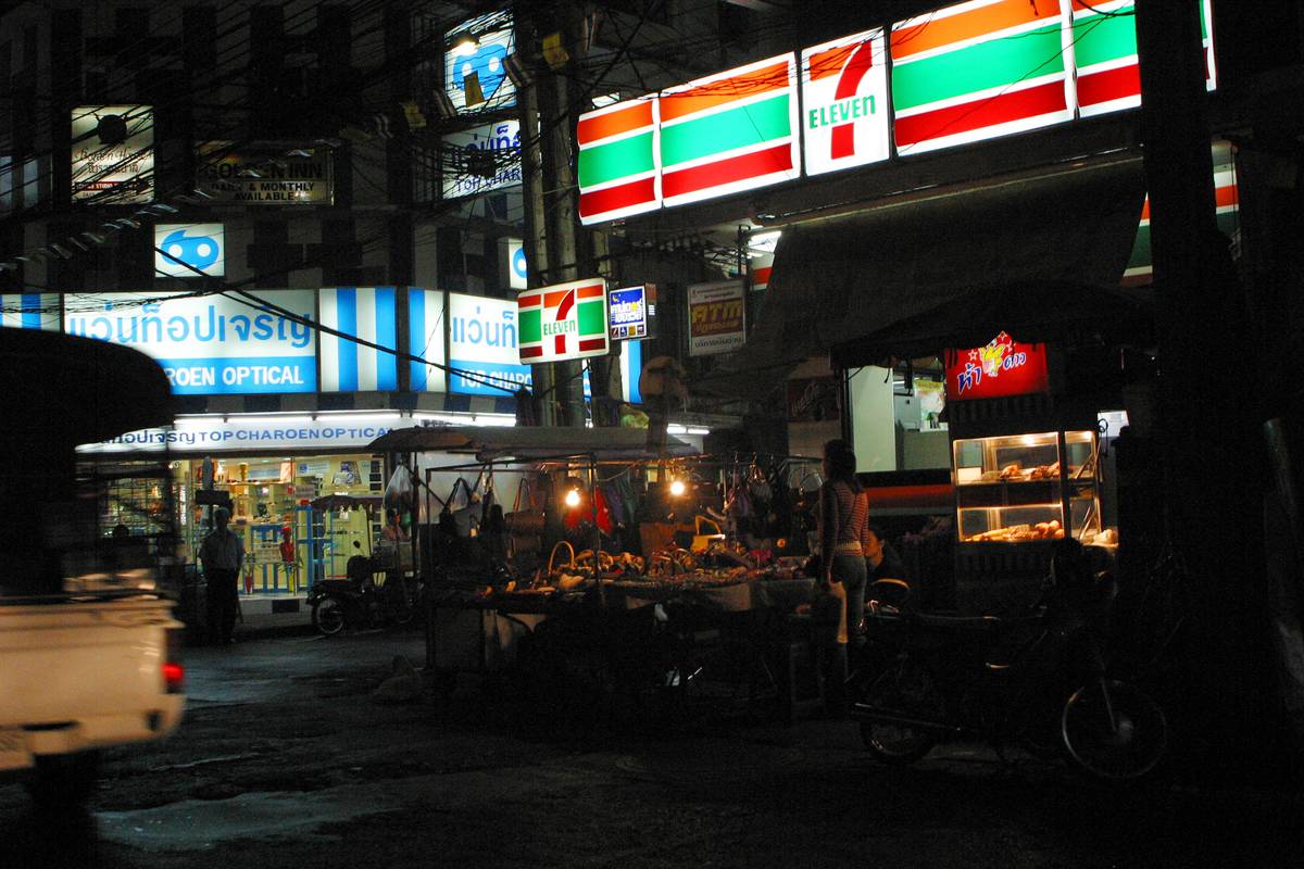 A Seven Eleven shop on a busy street corner of Bangkok, Thailand