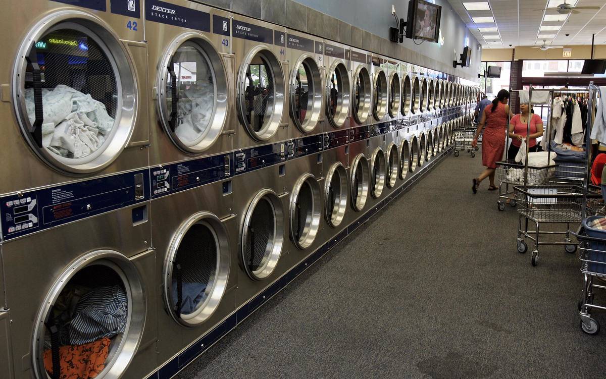 A long row of laundry dryers
