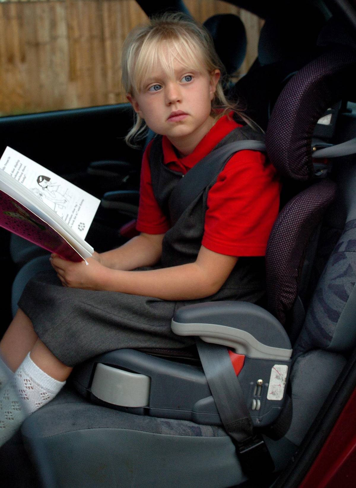 seven-year-old girl using a car seat
