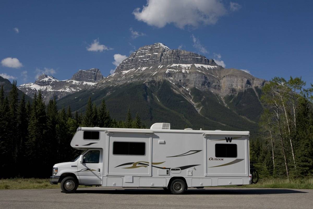 A large RV camper is parked off the Bow Valley Parkway in Banff