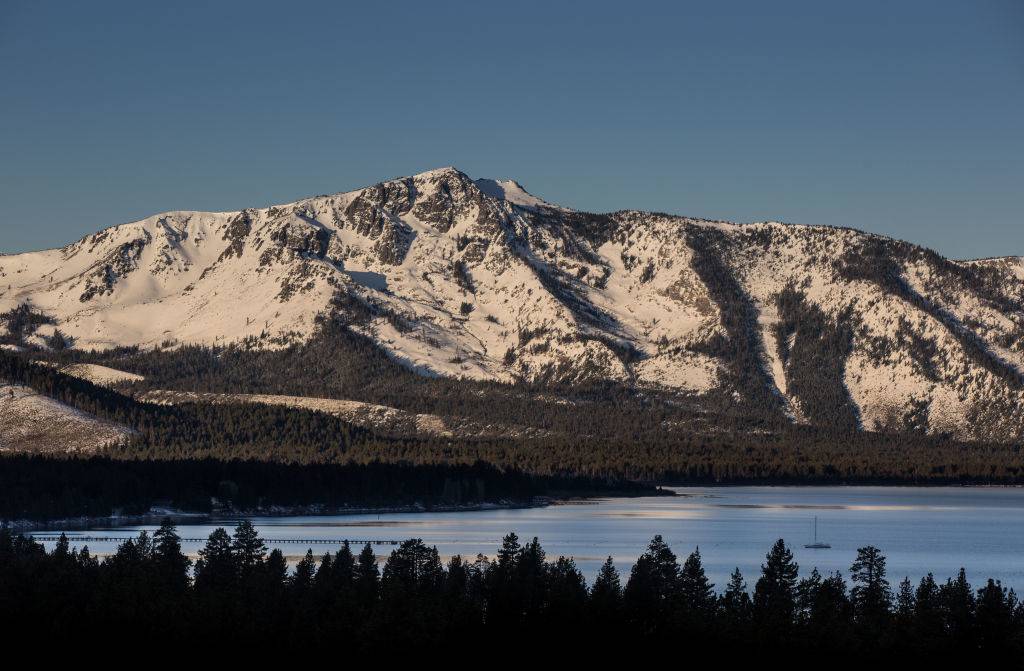 lake aloha trail in south lake tahoe with a snow-covered mountain, forest, and lake