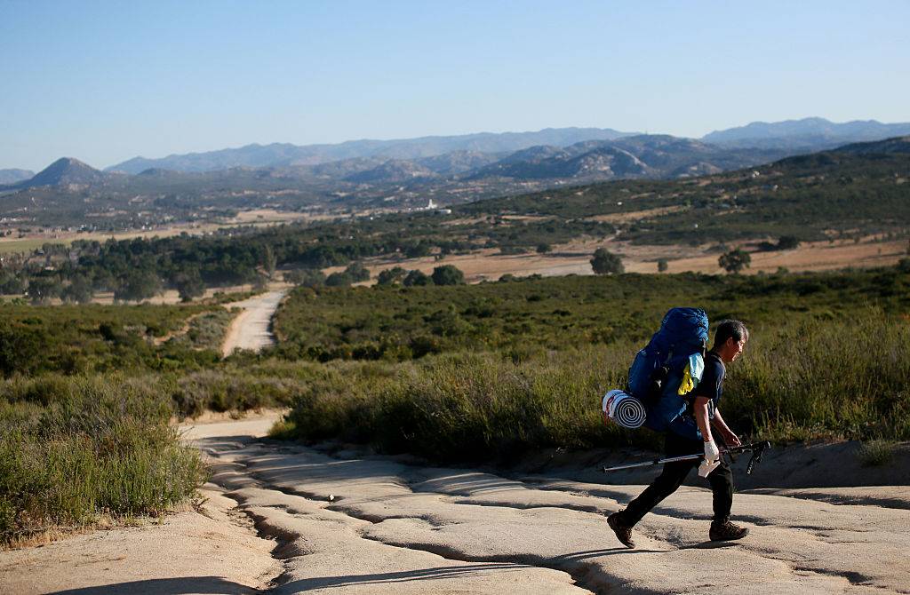 a backpacker walking along the pacific crest trail