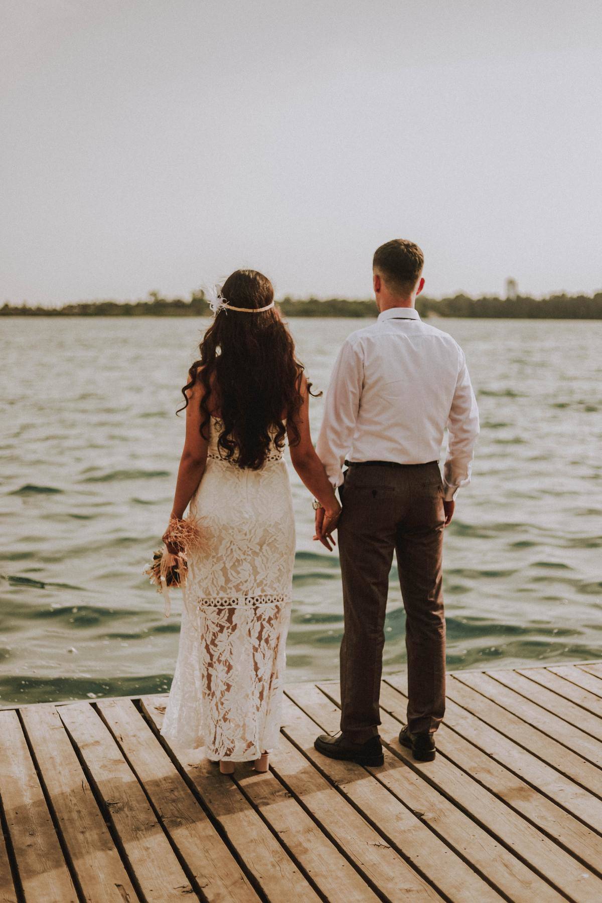 bride and groom looking at choppy water
