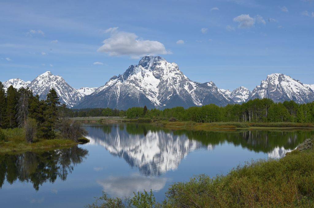 a lake in front of the mountains at Grand Teton National Park in Wyoming