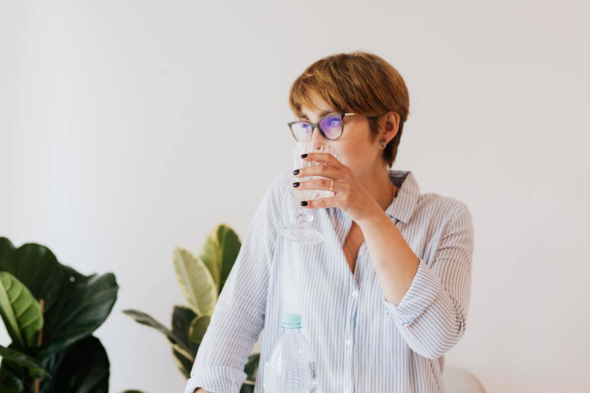 woman mid 30s with glass of water