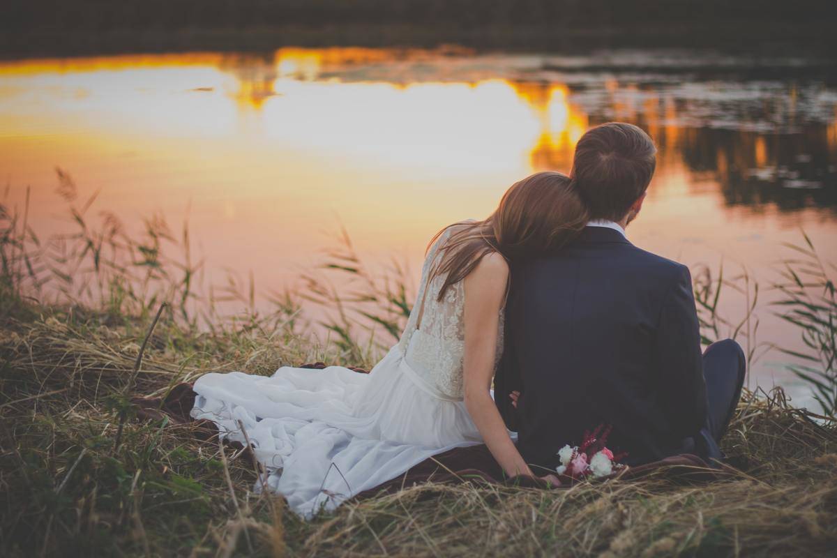 bride and groom watching sunset