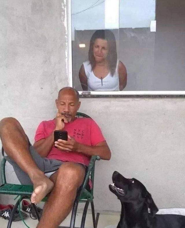 wife looking over husband's shoulder at phone