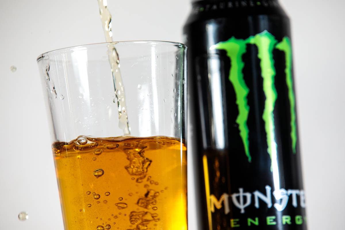 Monster energy drink gets poured into a glass.
