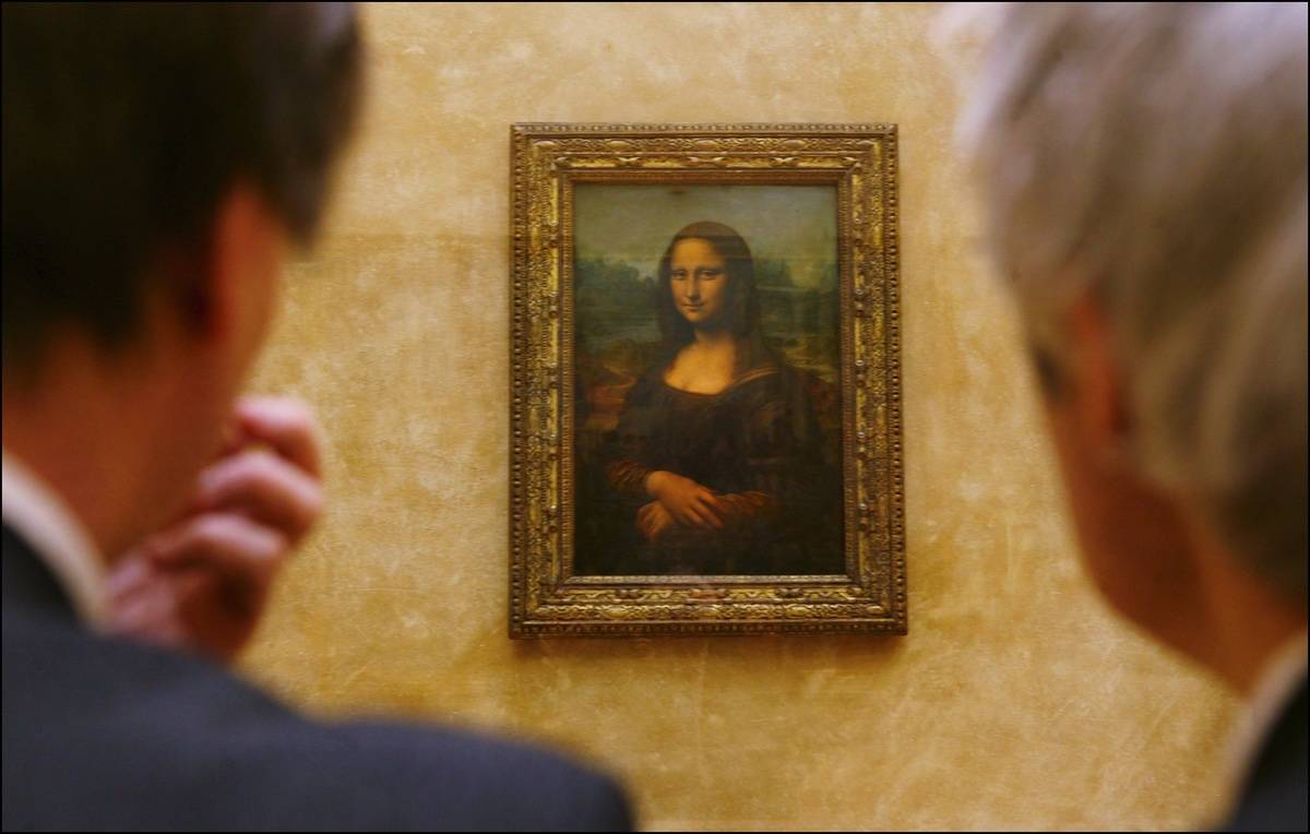Two men look at The Mona Lisa.