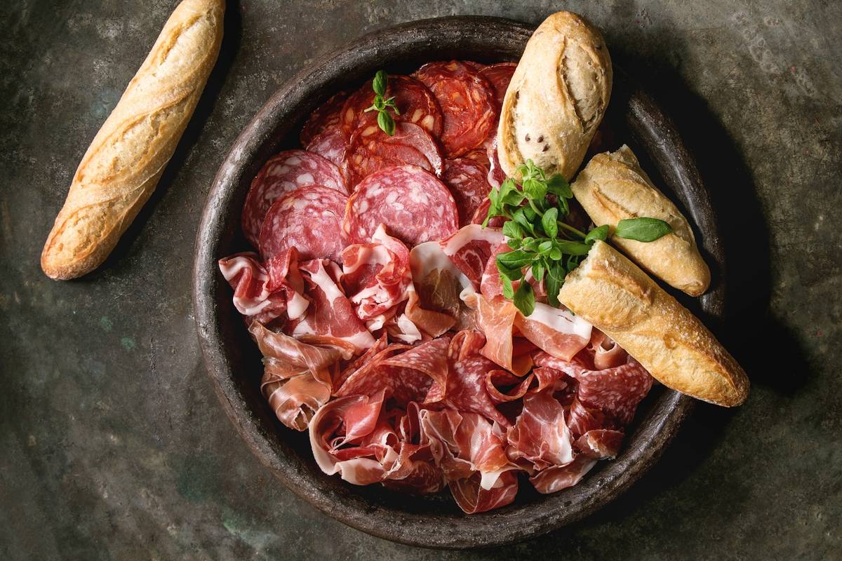 An Antipasto meat platter is served with bread.