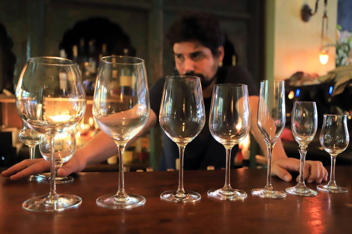 Empty wine glasses are at a bar in Israel.