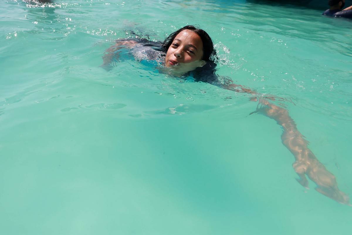 A girl swims in a pool.