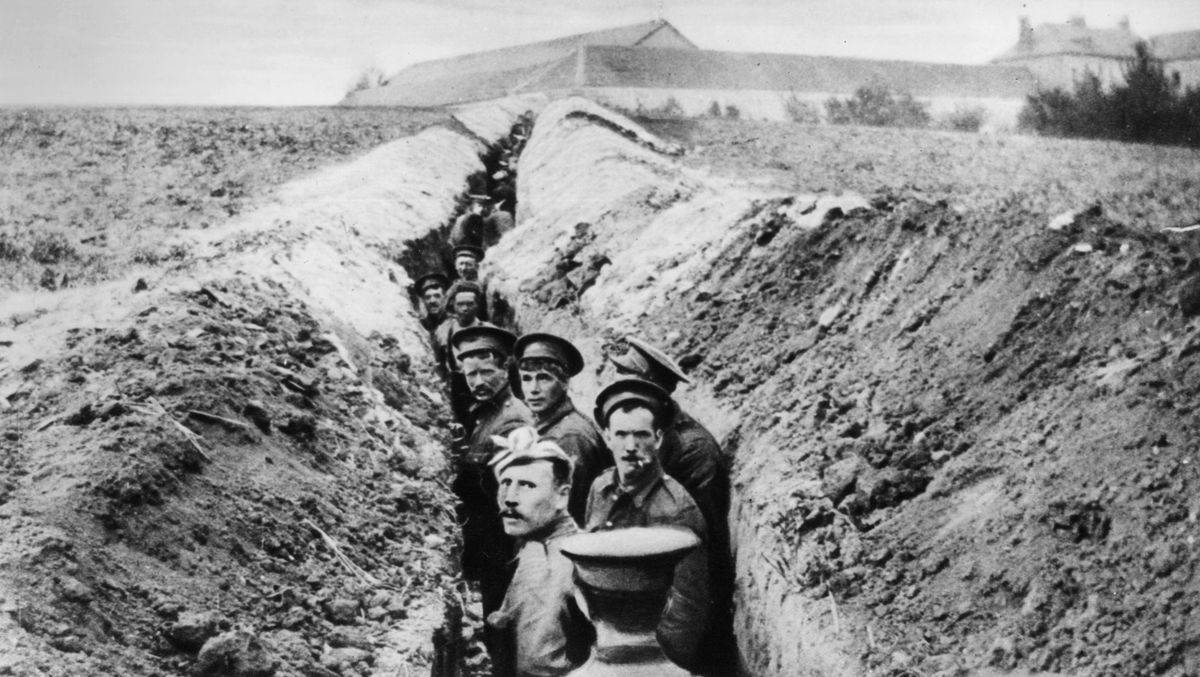 British soldiers lined up in a narrow trench during World War I