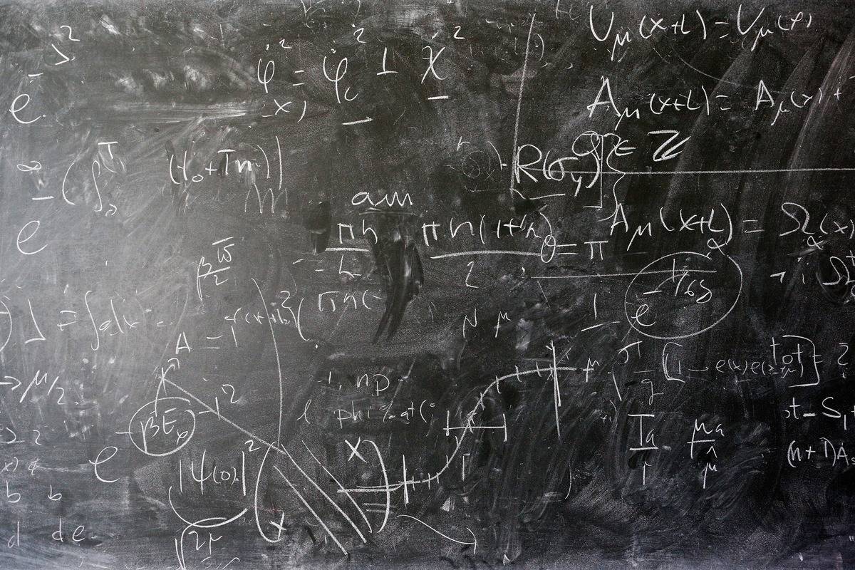 A detailed view of the blackboard with theoretical physics equations in chalk