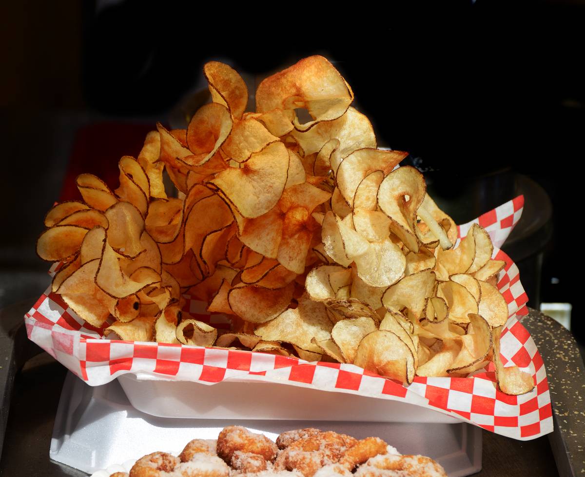 Potato chips are piled onto a plate at a Spanish Market.