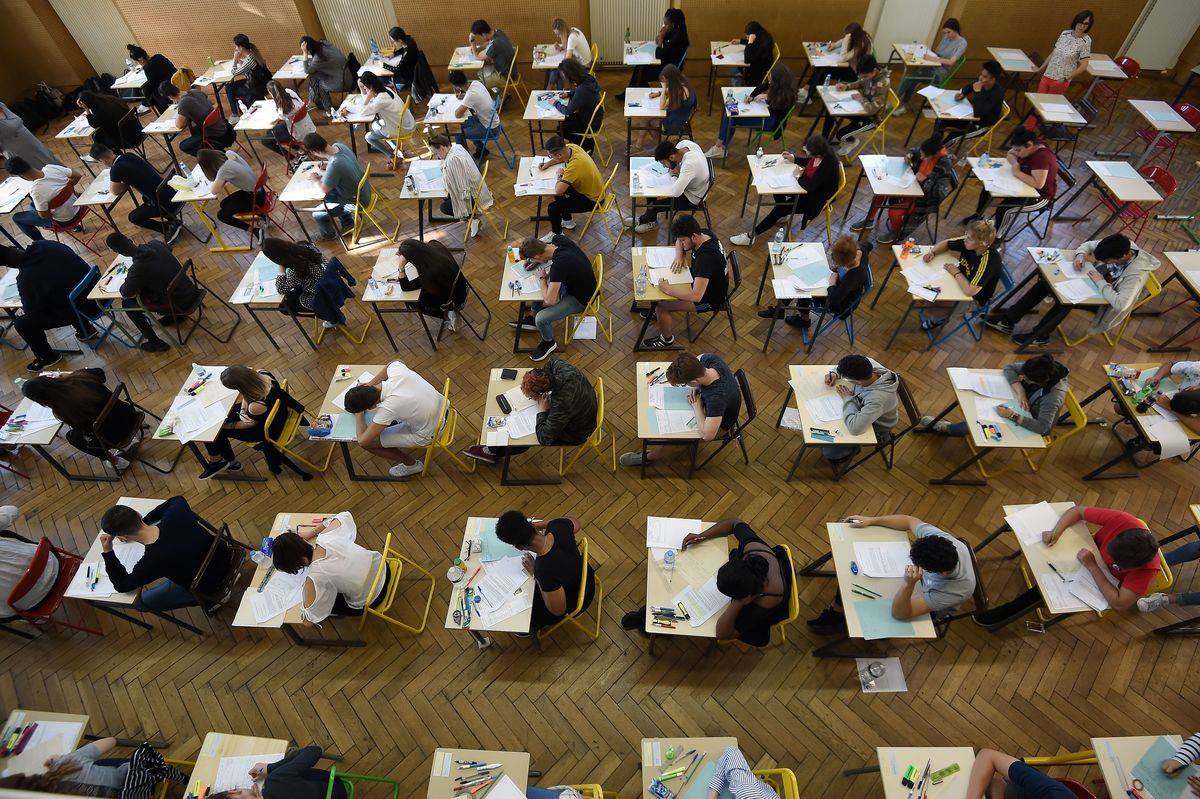 students writing test in rows of desks