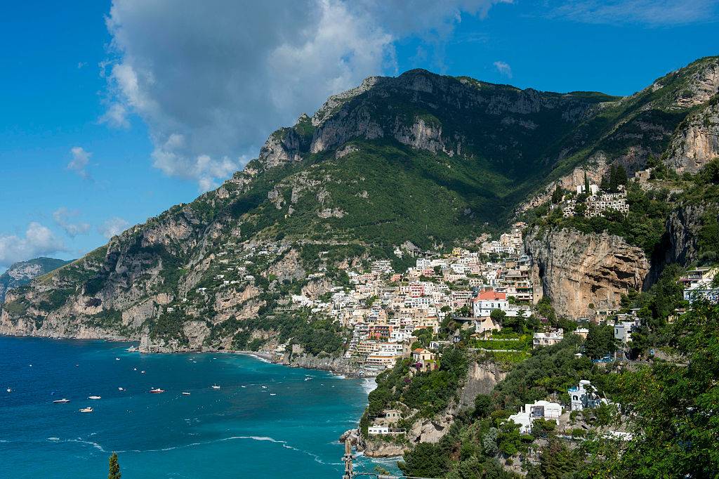 view of the amalfi coast with homes on a hill near the beach