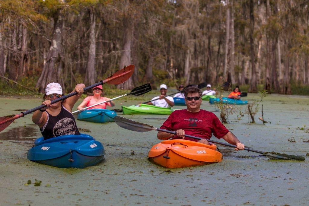 people kayaking in a swamp in Breaux Bridge, Louisiana
