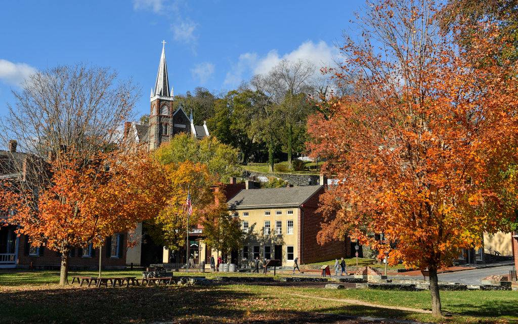 the historic district with a church and colorful trees in Harpers Ferry, West Virginia