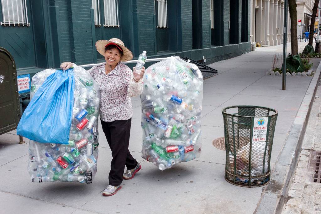 A woman with bags of recycling aluminum cans. 