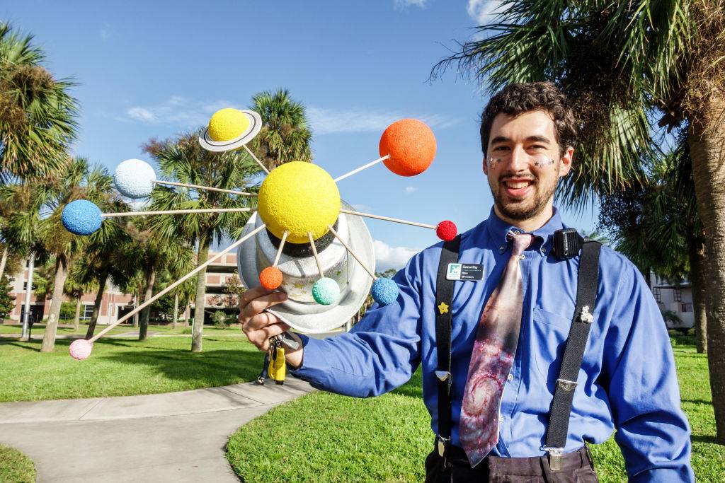 University of Florida Museum of Natural History, man holding Solar System model