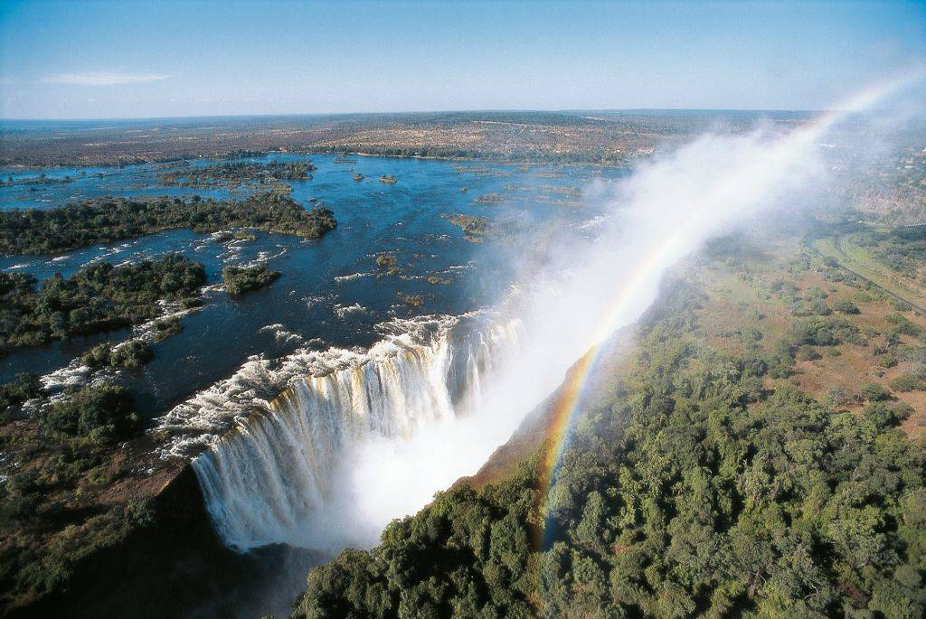 aerial view of victoria falls with a rainbow