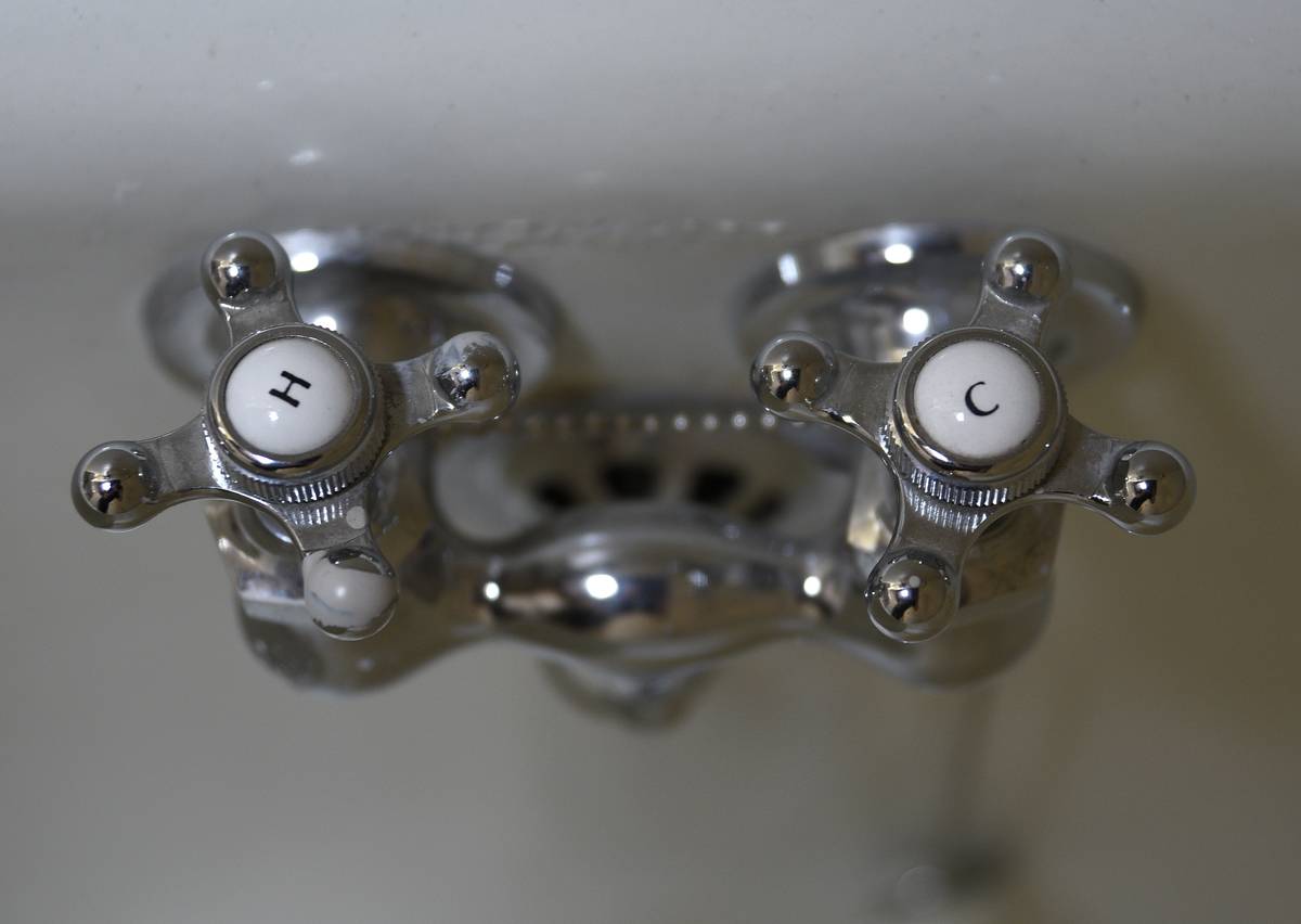 Handles of a bathtub faucet are pictured.