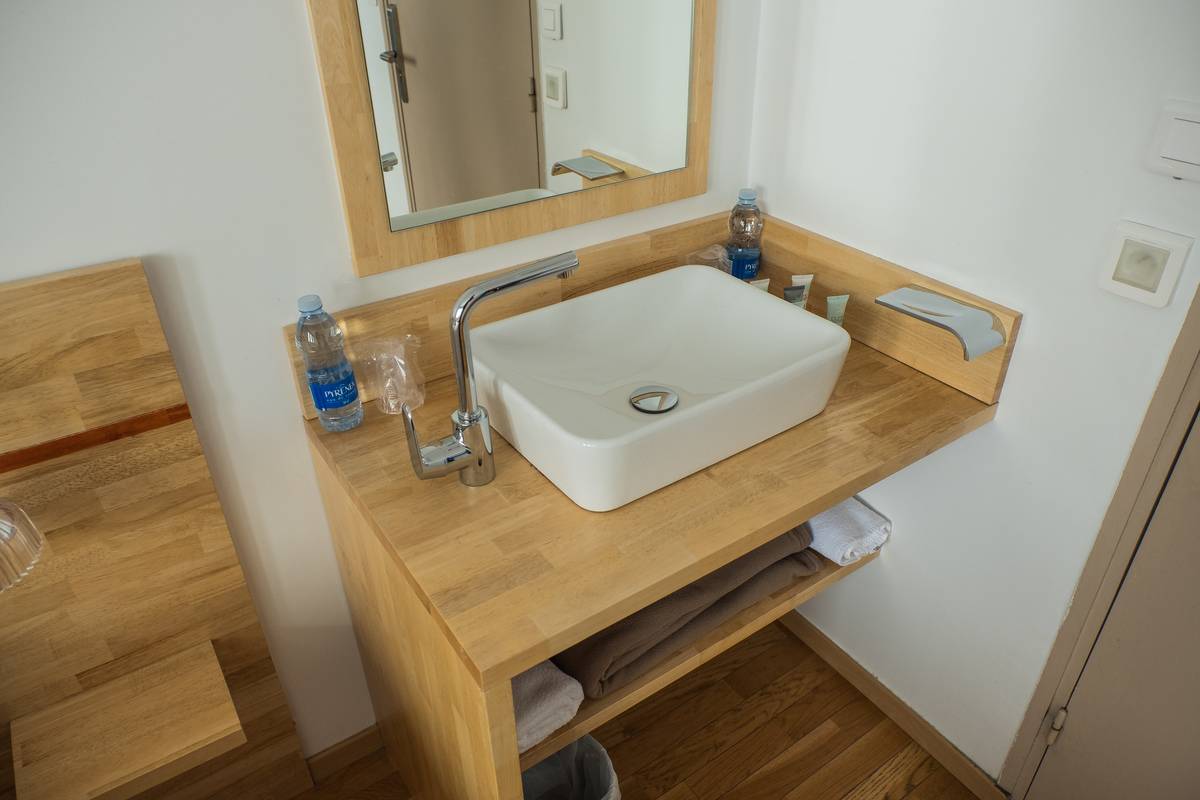 A square bathroom sink is pictured.