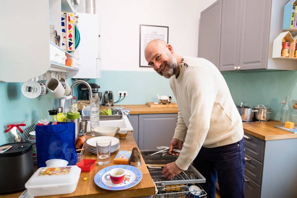 man washing dishes