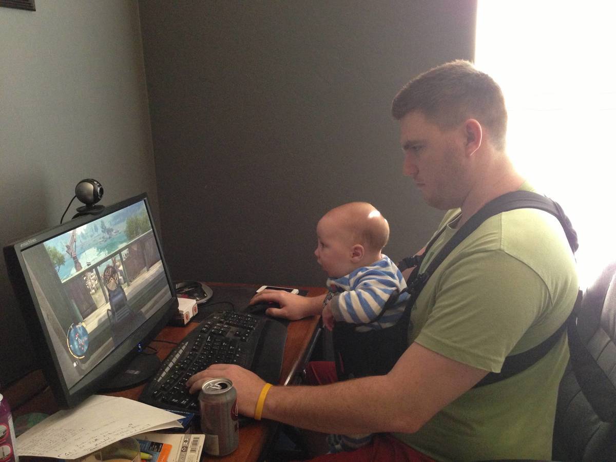 husband put baby in snuggly so he could play computer games 