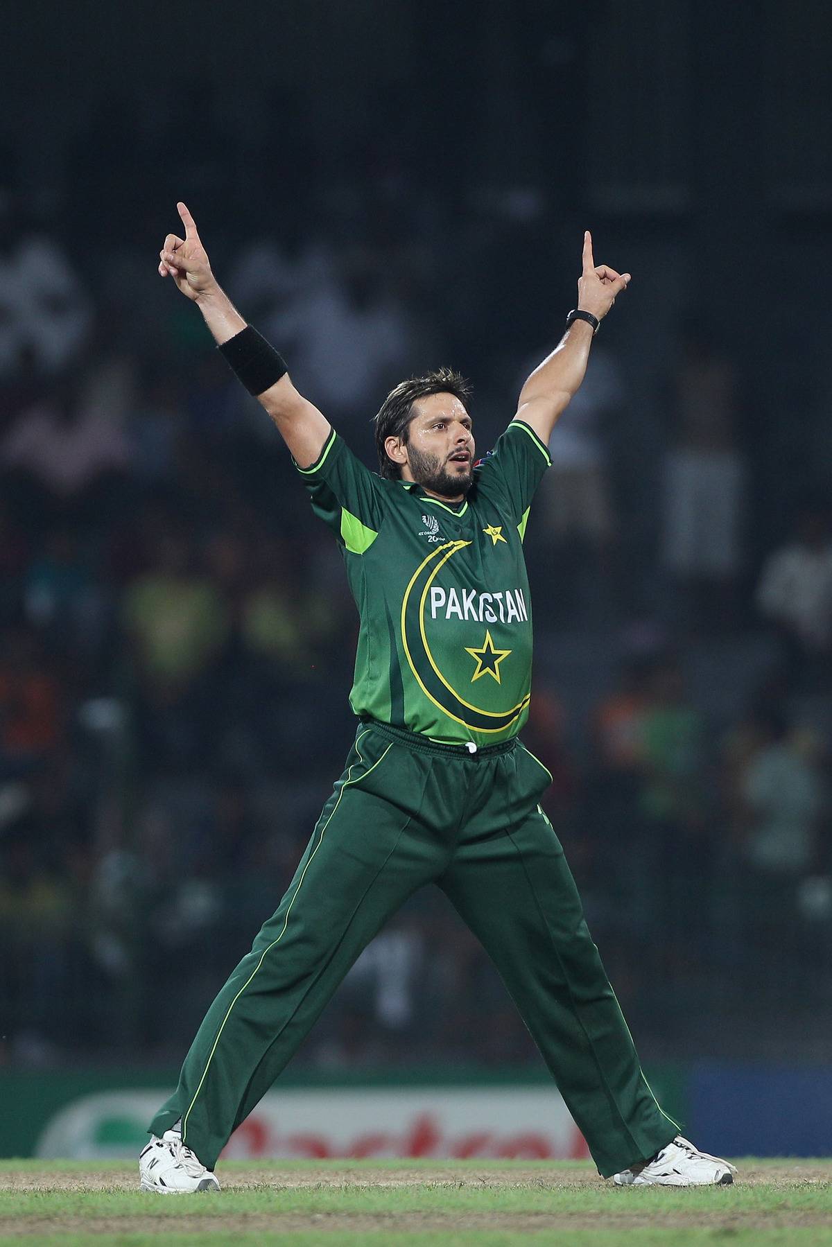Shahid Afridi celebrates on the cricket field.