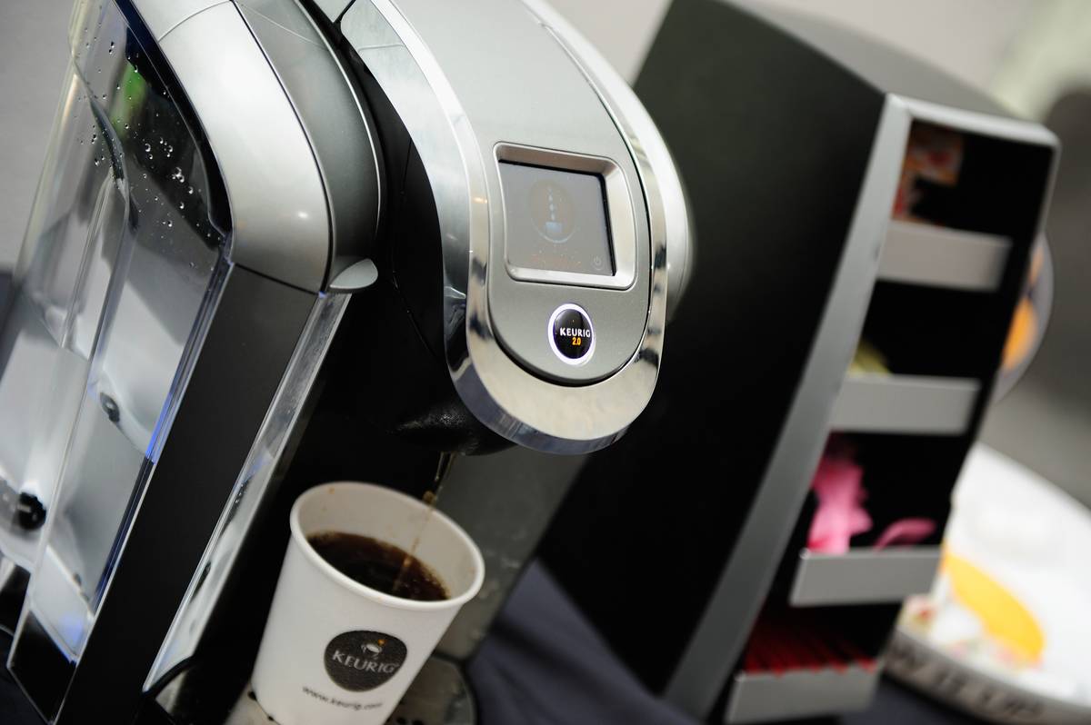 A Keurig machine brews coffee.