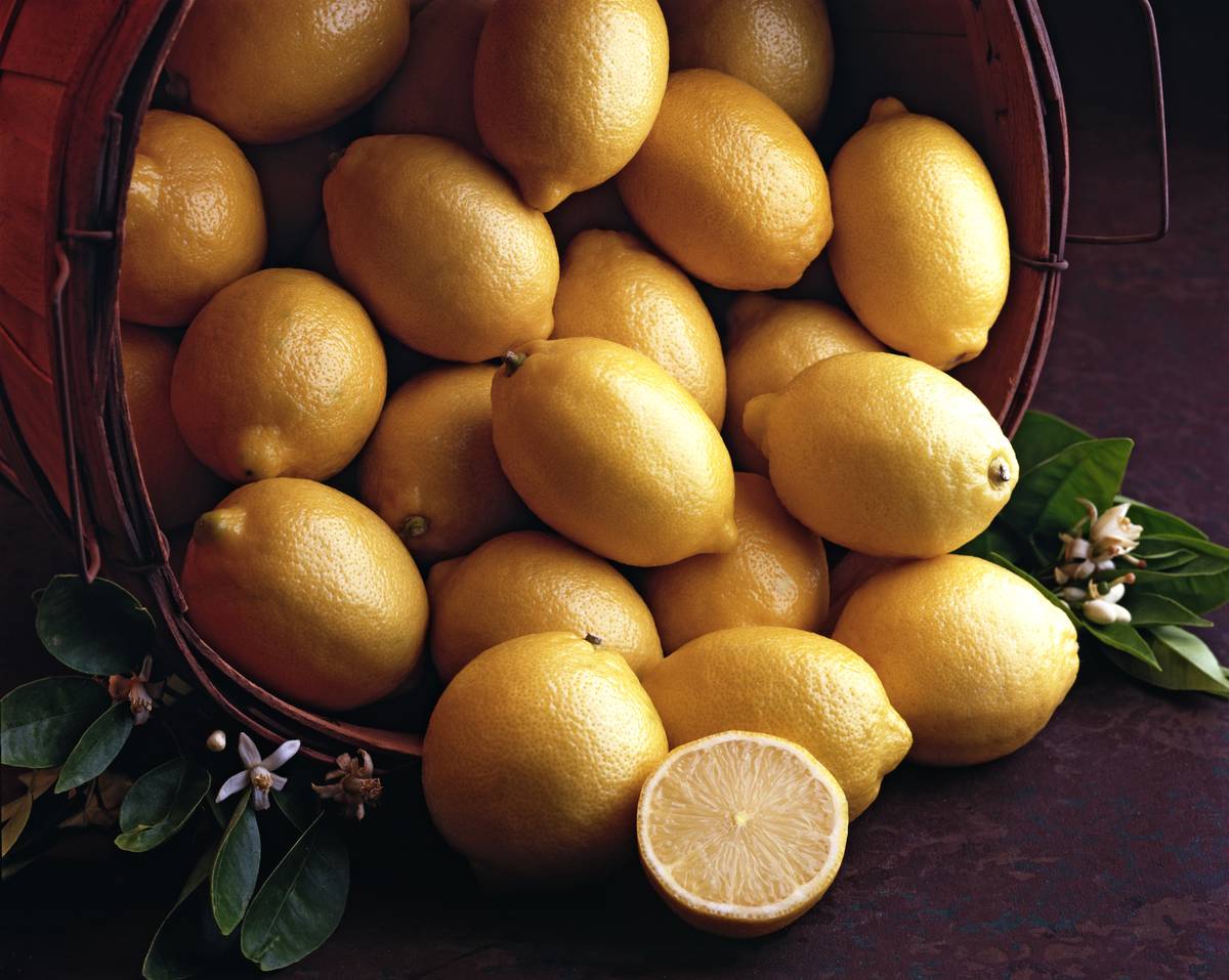View of a basket of lemons, with one lemon cut in half