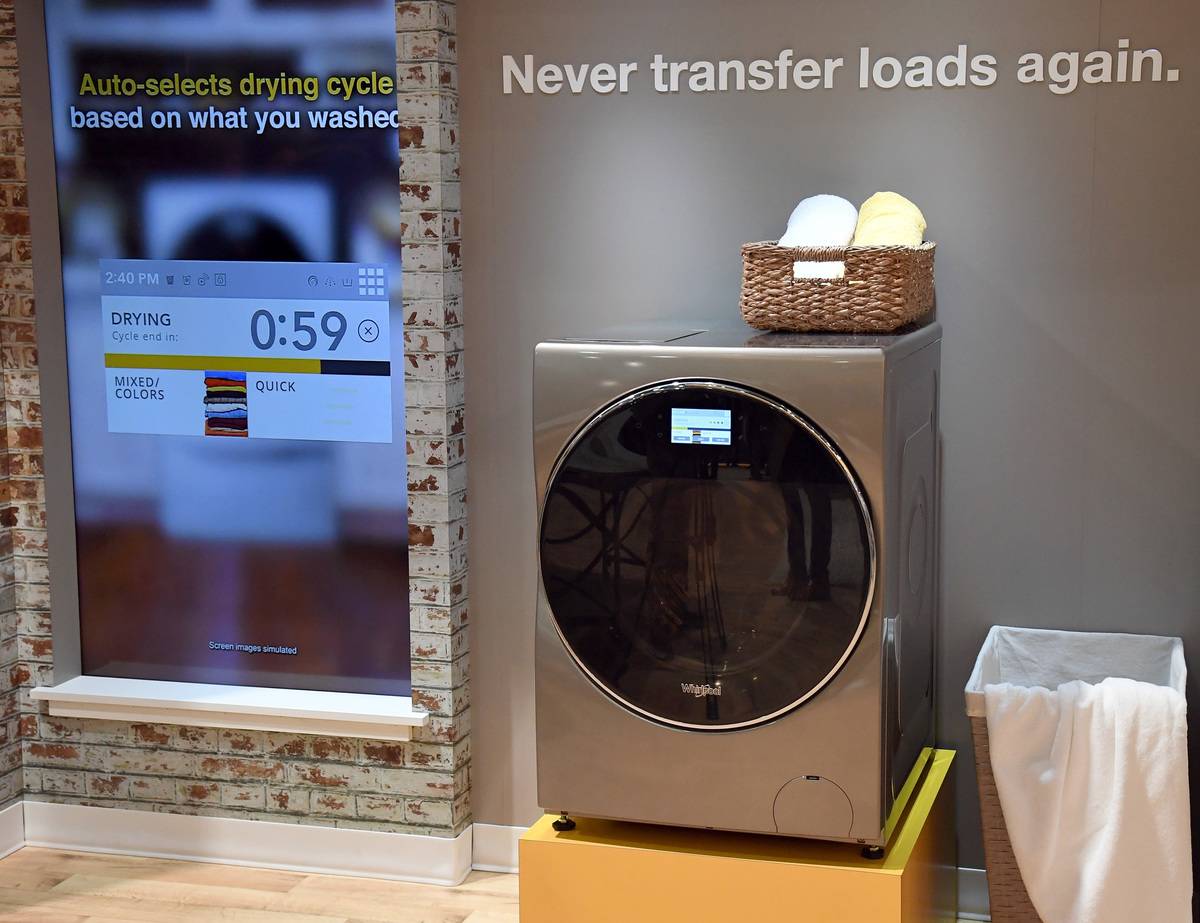 An all-in-one washer dryer combo is on display at an expo.