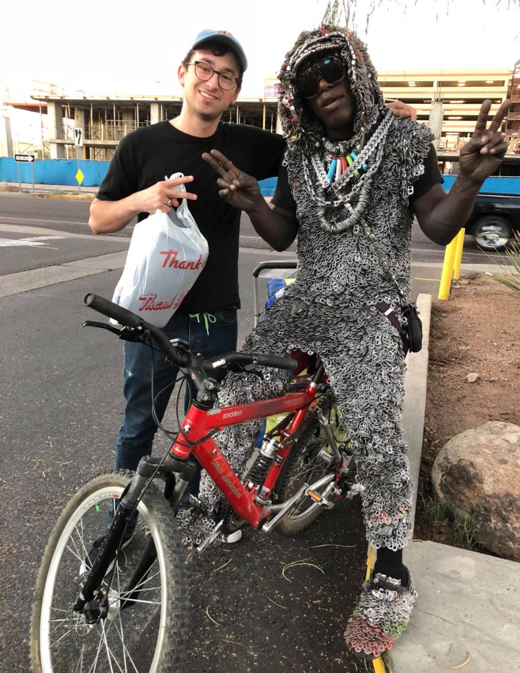 man's entire outfit is made of pop can tabs
