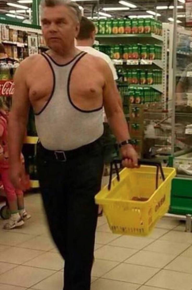 man wears racerback tank top backwards so that nips are exposed in grocery store