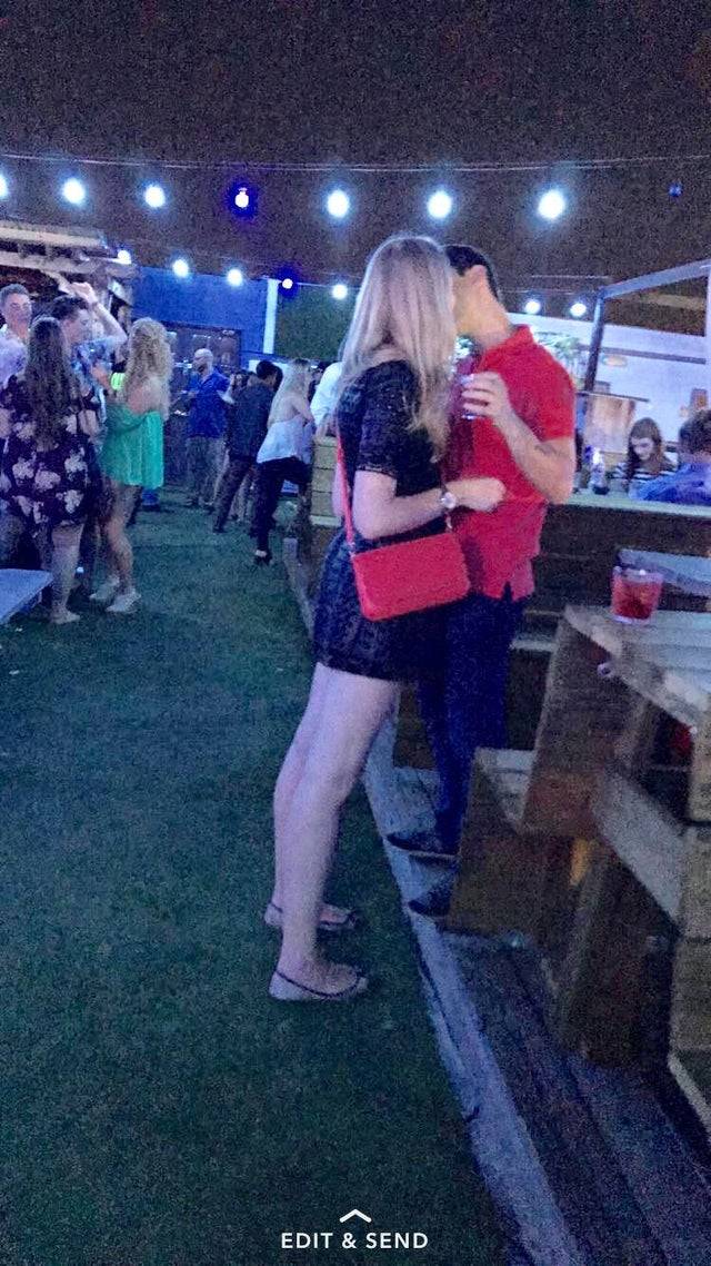 Tall Girl kisses guy At the Bar
