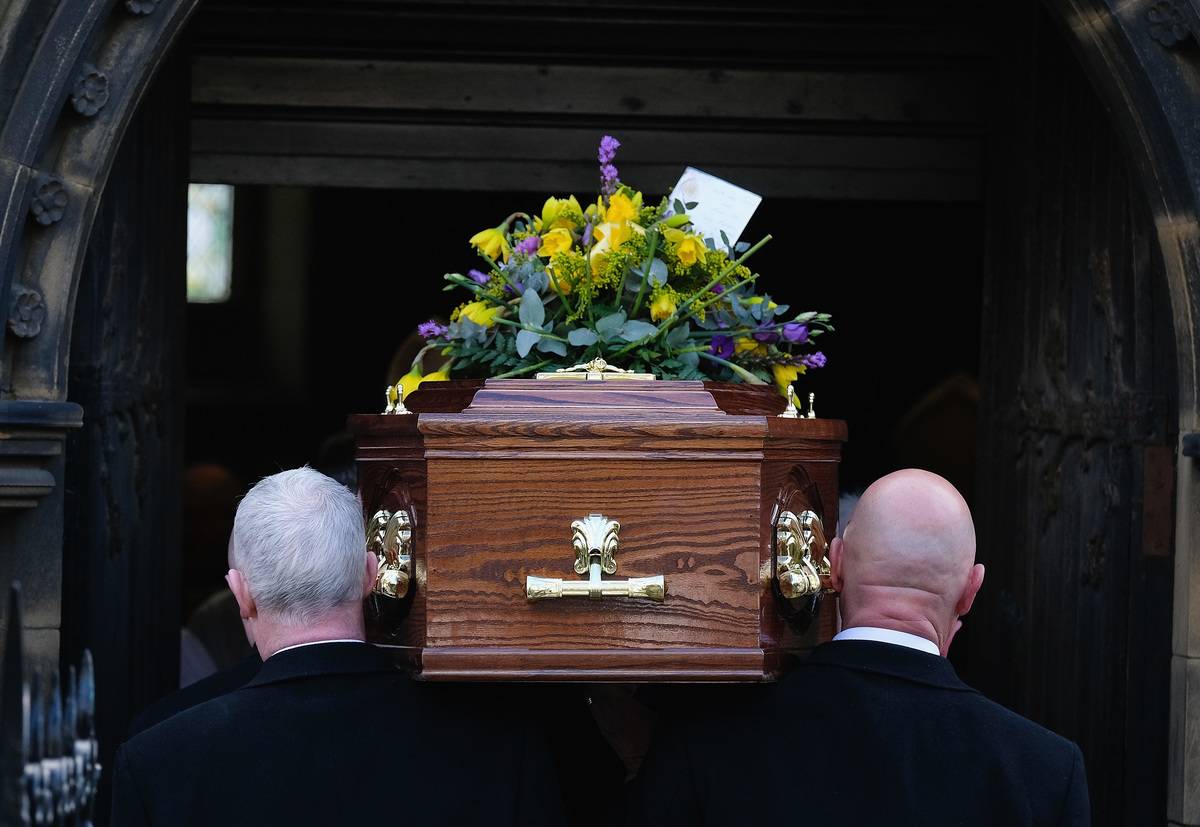 The coffin is carried into a funeral