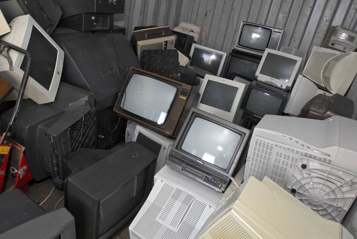 Unwanted televisions lie in a giant pile.