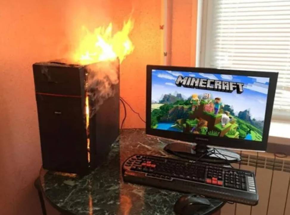 computer box on fire next to monitor