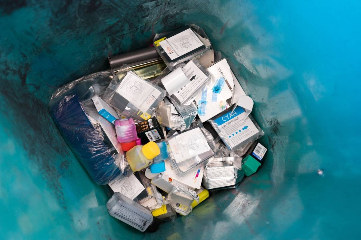 Used ink cartridges lie in the trash.