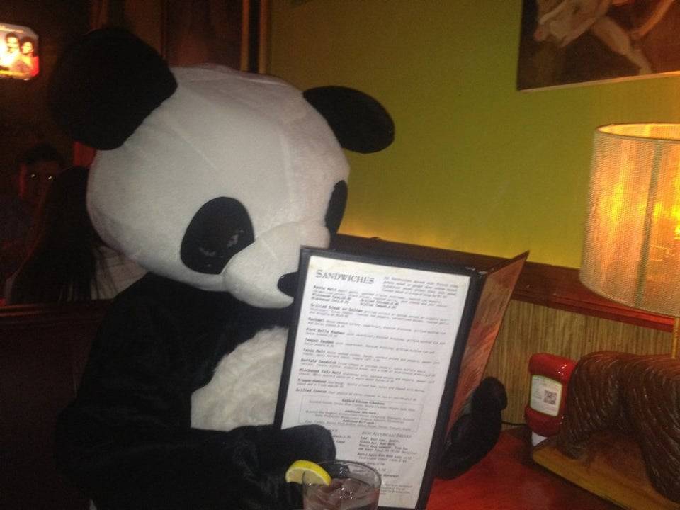 man dressed as panda in normal restaurant