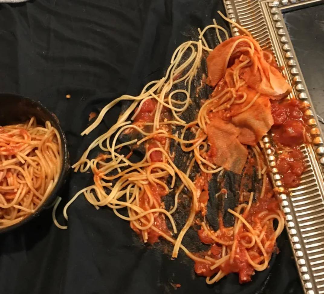 spaghetti with red sauce spilled all over bed sheet