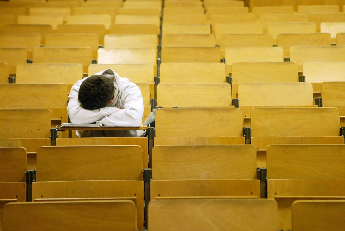 A student naps in a lecture hall