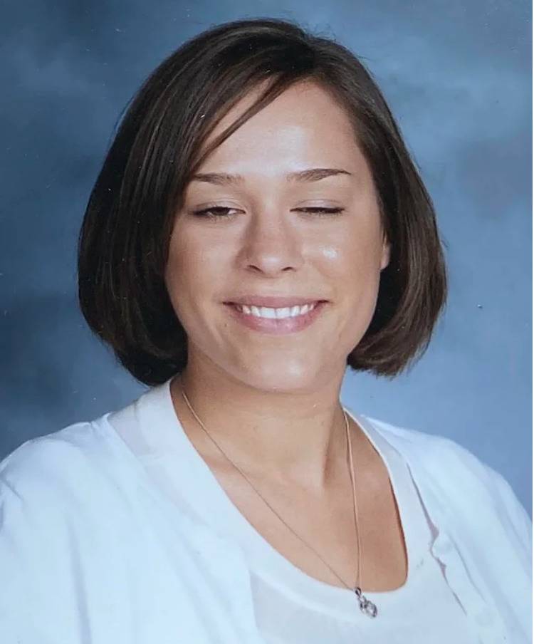 woman has eyes weirdly half-closed in school photo