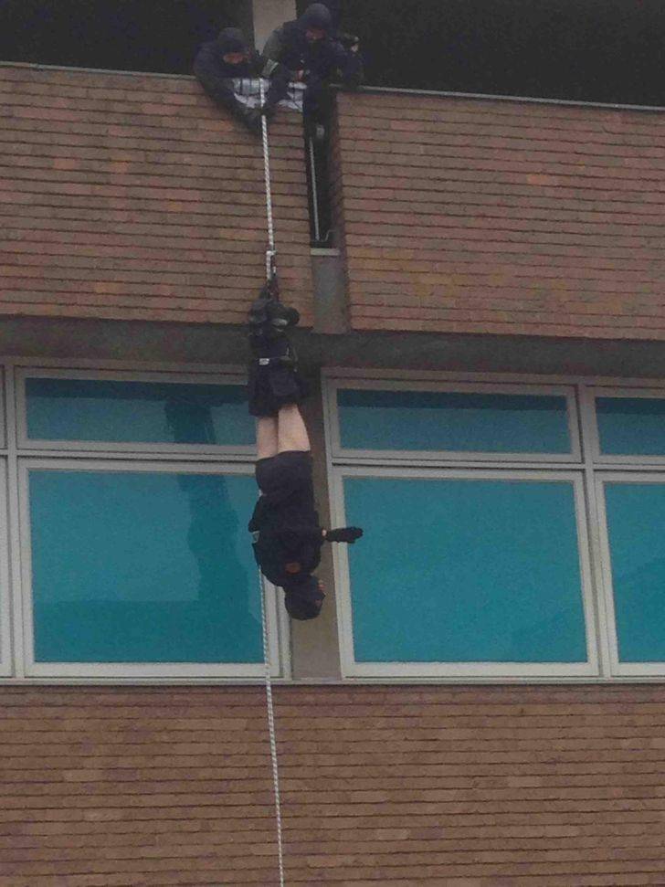 man hanging upside down pants fallen
