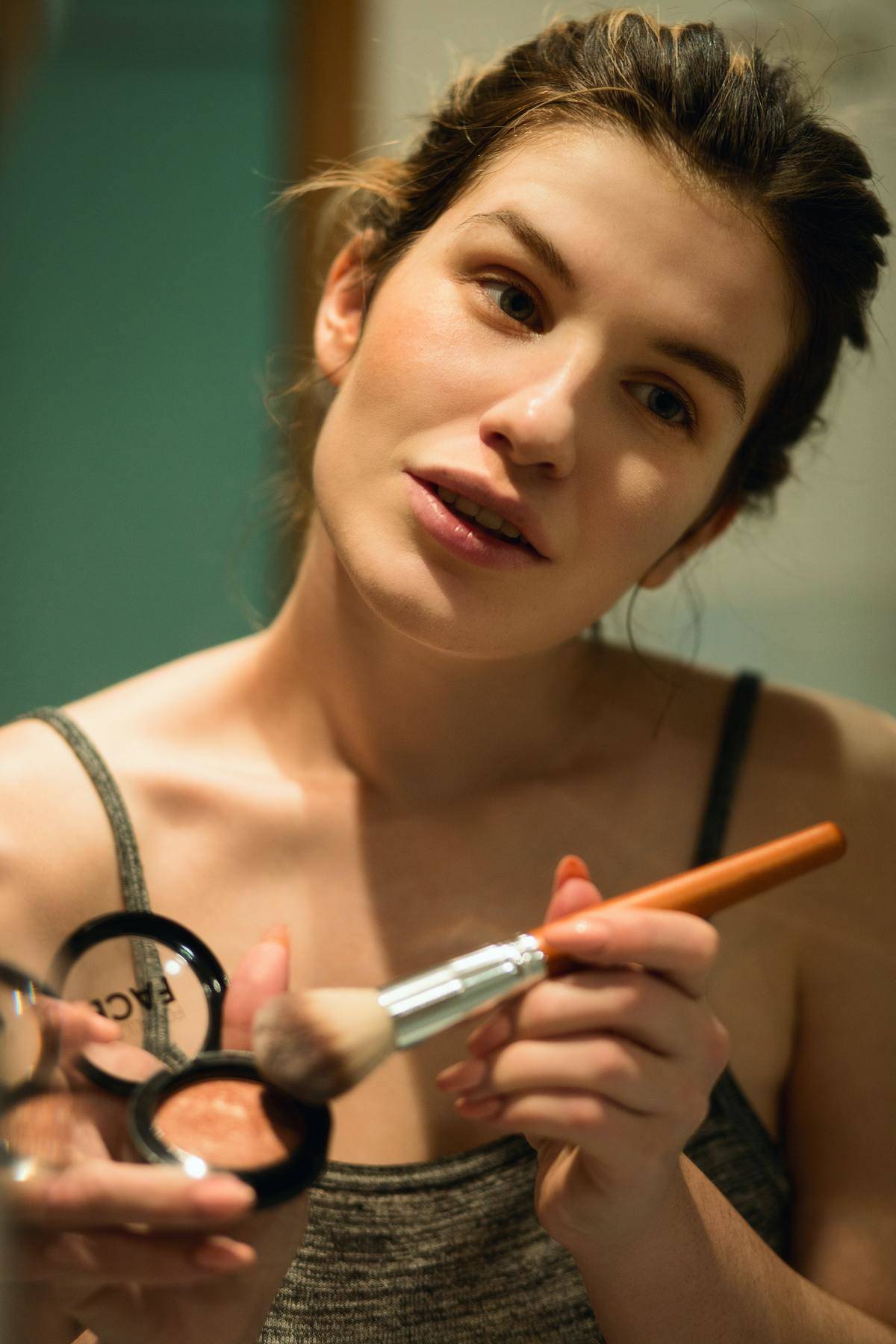 woman applies blush